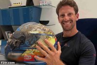 Grosjean embraces the helmet that saved him from the Bahrain inferno